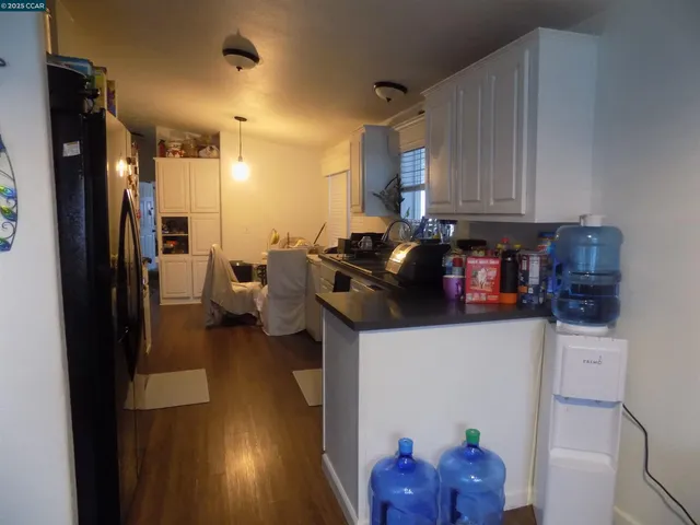 a kitchen with stainless steel appliances a refrigerator sink and cabinets