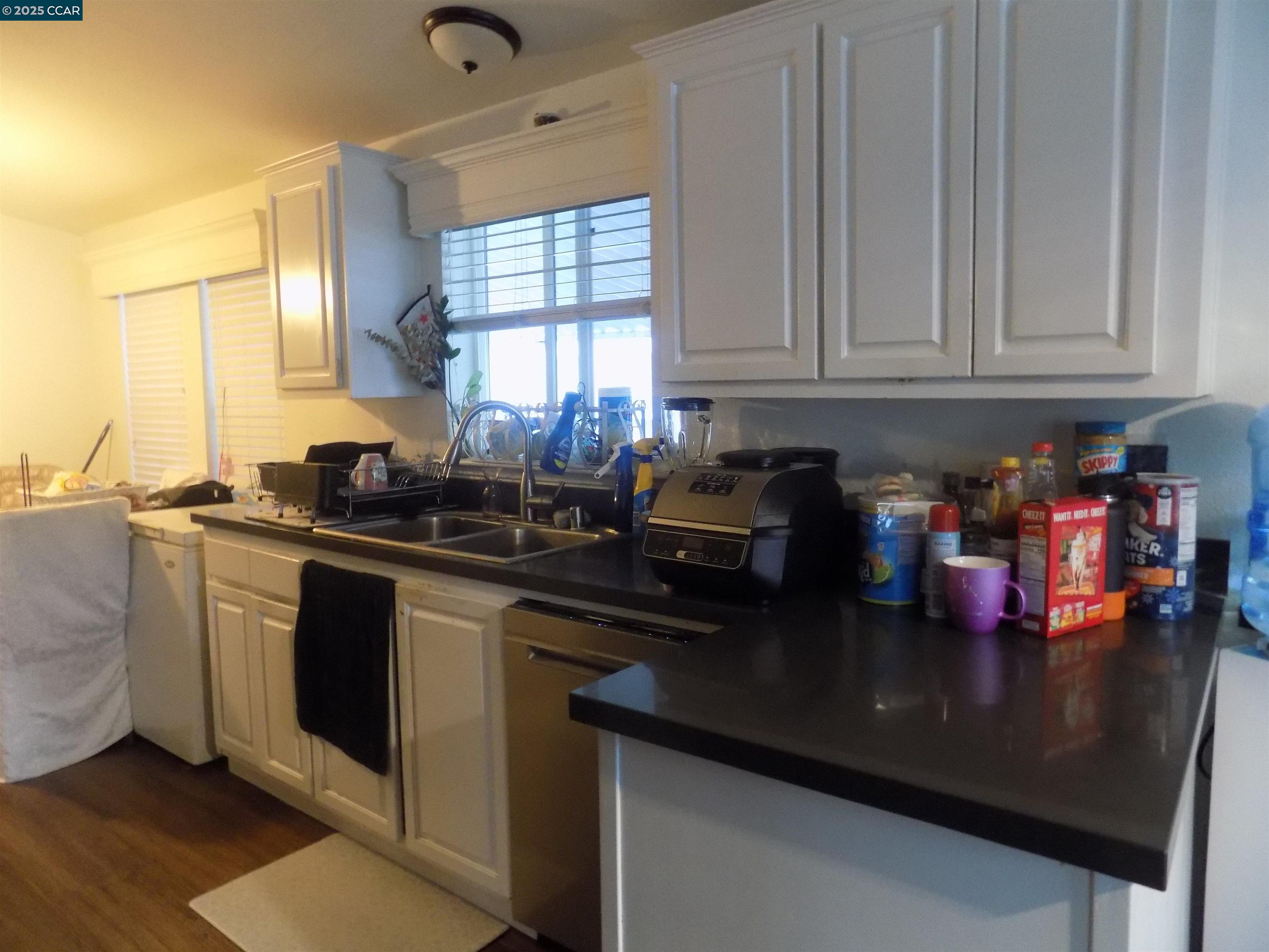 55 Pacifica Avenue, Unit 146 Bay Point, CA 94565 - Photo 7 of 18 a kitchen with granite countertop a sink stove and cabinets