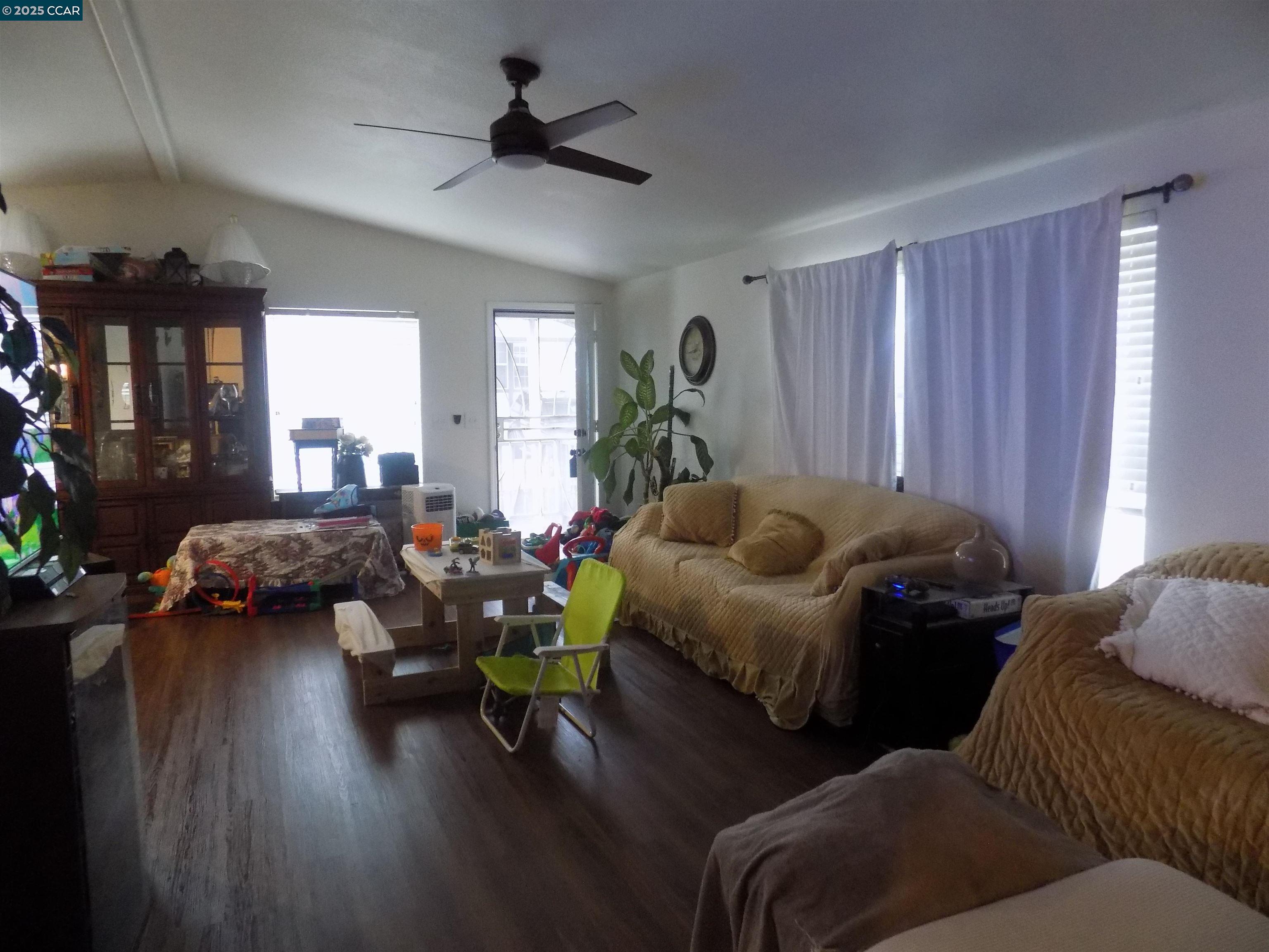 55 Pacifica Avenue, Unit 146 Bay Point, CA 94565 - Photo 10 of 18 a living room with furniture and a wooden floor