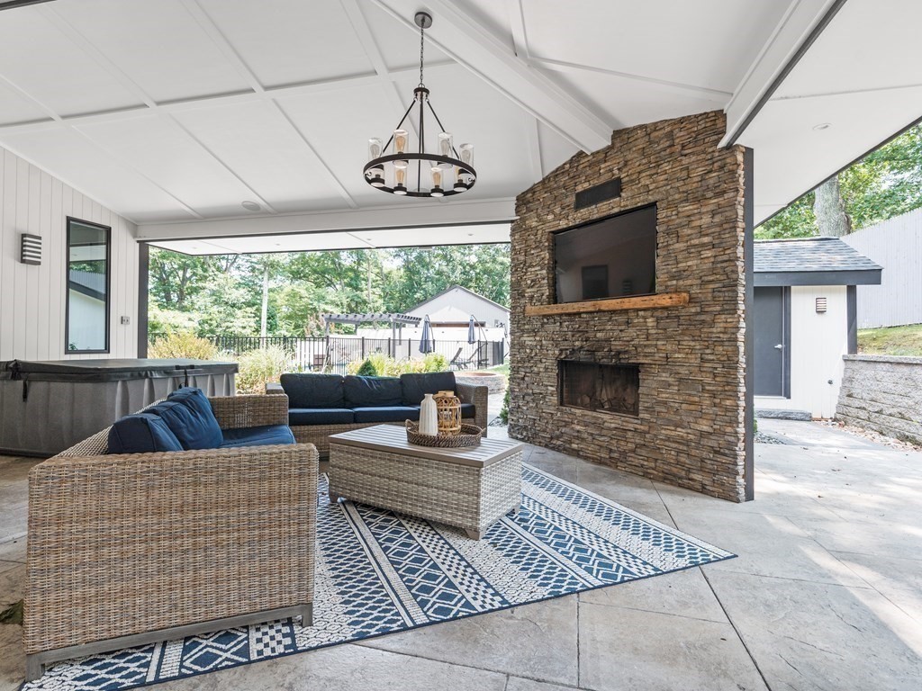 49 Reed Street Rehoboth, MA 02769 - Photo 35 of 40 a living room with furniture a flat screen tv and a fireplace