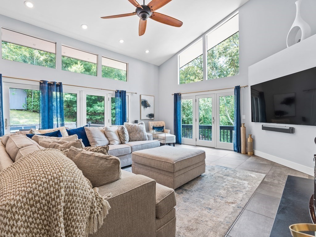 49 Reed Street Rehoboth, MA 02769 - Photo 10 of 40 a large bedroom with large windows and a flat screen tv