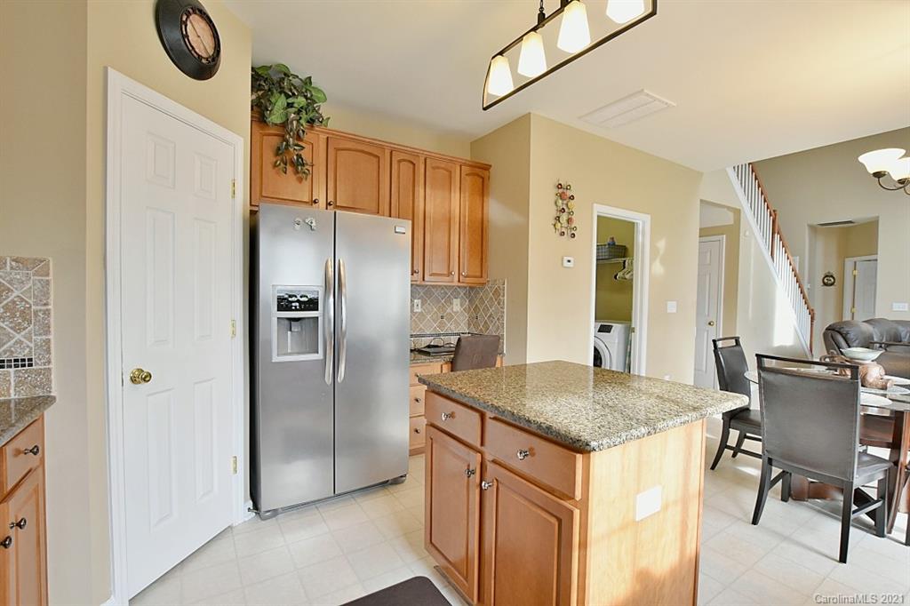 6306 Hawks Eye Court Fort Mill, SC 29708 - Photo 12 of 26 a kitchen with a table chairs refrigerator and cabinets