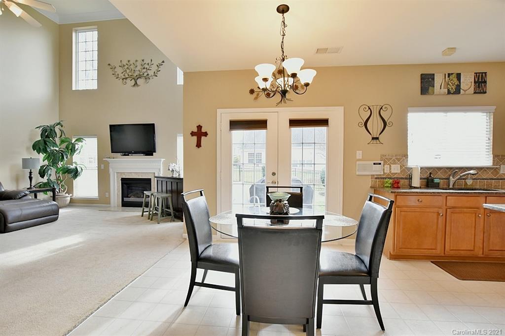 6306 Hawks Eye Court Fort Mill, SC 29708 - Photo 14 of 26 a view of a dining room with furniture a chandelier and wooden floor