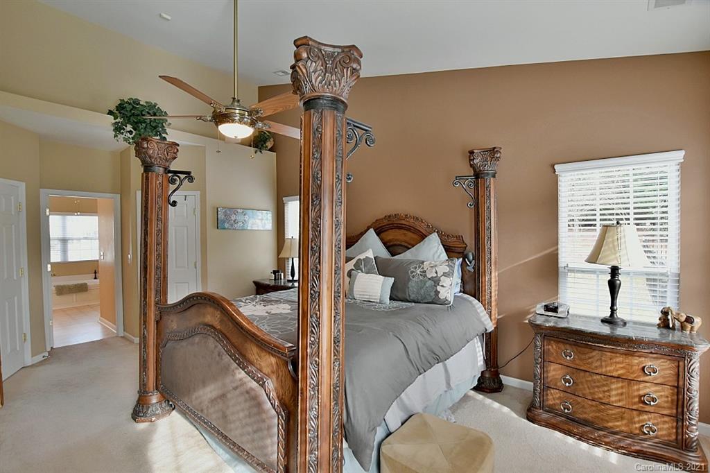 6306 Hawks Eye Court Fort Mill, SC 29708 - Photo 15 of 26 a bed room with a bed and a chandelier