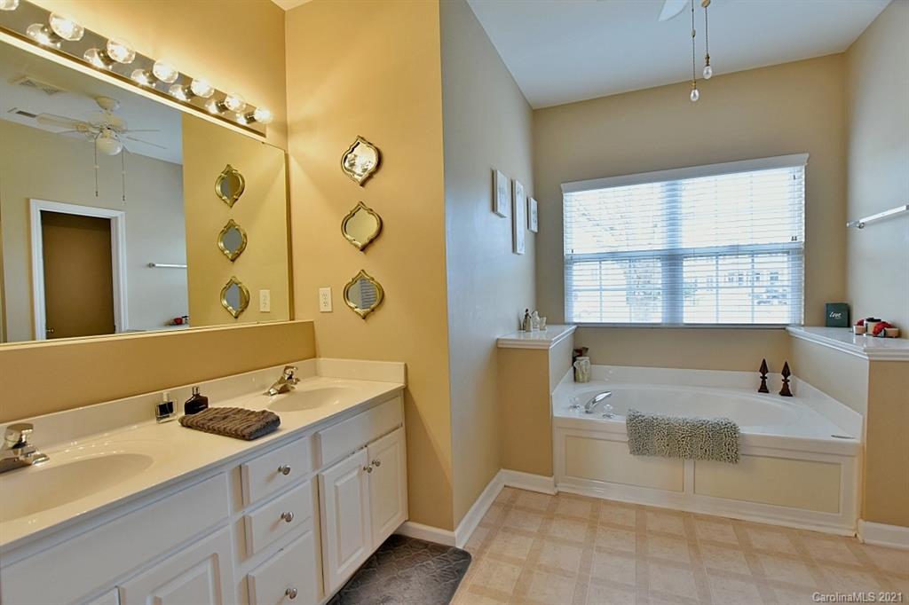 6306 Hawks Eye Court Fort Mill, SC 29708 - Photo 17 of 26 a spacious bathroom with a tub sink and mirror