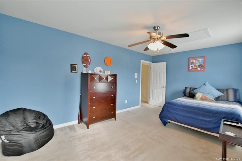 6306 Hawks Eye Court Fort Mill, SC 29708 - Photo 19 of 26 a bedroom with furniture and a chandelier fan