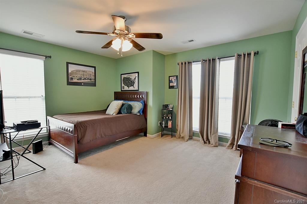 6306 Hawks Eye Court Fort Mill, SC 29708 - Photo 22 of 26 a bedroom with a bed and a chandelier
