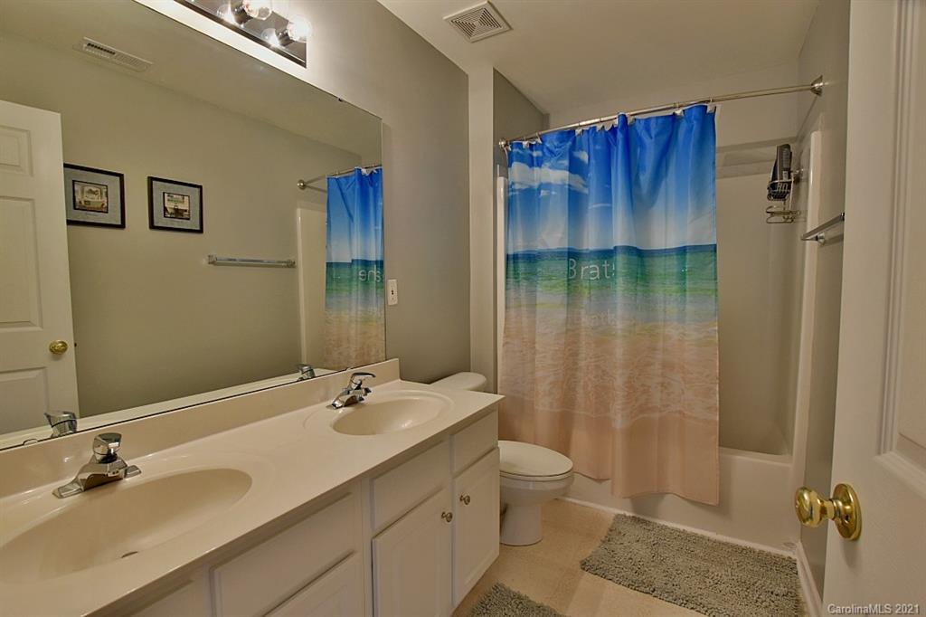 6306 Hawks Eye Court Fort Mill, SC 29708 - Photo 23 of 26 a bathroom with a granite countertop sink a toilet and shower
