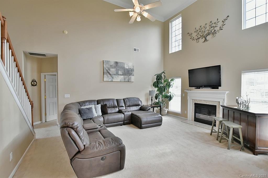 6306 Hawks Eye Court Fort Mill, SC 29708 - Photo 7 of 26 a living room with furniture a fireplace and a flat screen tv