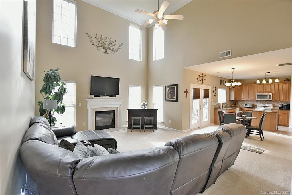 6306 Hawks Eye Court Fort Mill, SC 29708 - Photo 8 of 26 a living room with furniture a fireplace and a flat screen tv