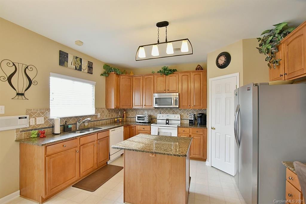 6306 Hawks Eye Court Fort Mill, SC 29708 - Photo 9 of 26 a kitchen with stainless steel appliances granite countertop a sink a stove and refrigerator