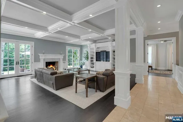 a living room with fireplace furniture and a large window