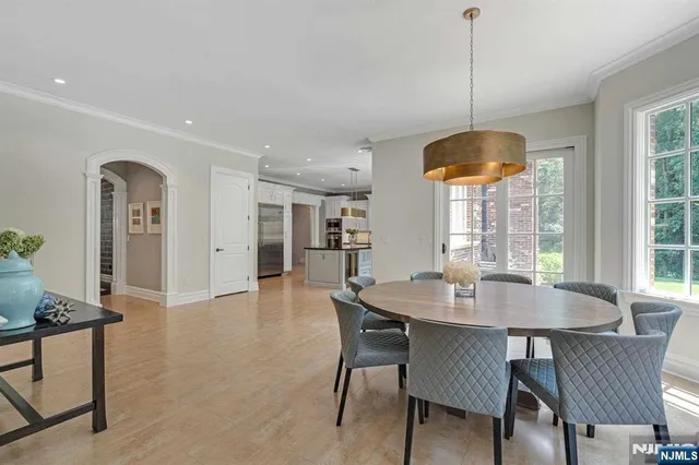 a dining room with furniture a chandelier and wooden floor