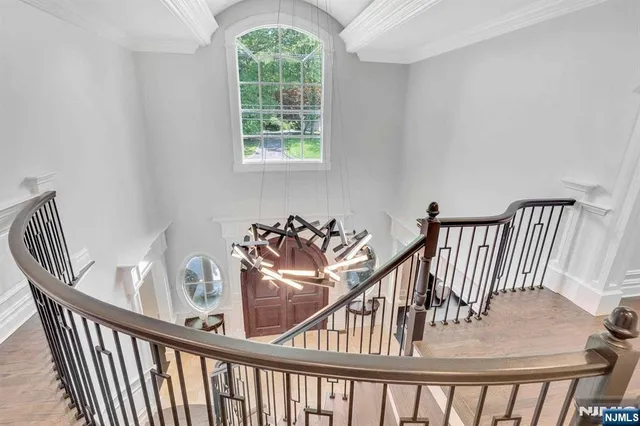 a view of a hallway with windows and stairs