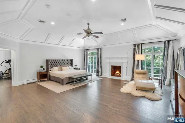 a spacious bedroom with a balcony a bed and a flat screen tv