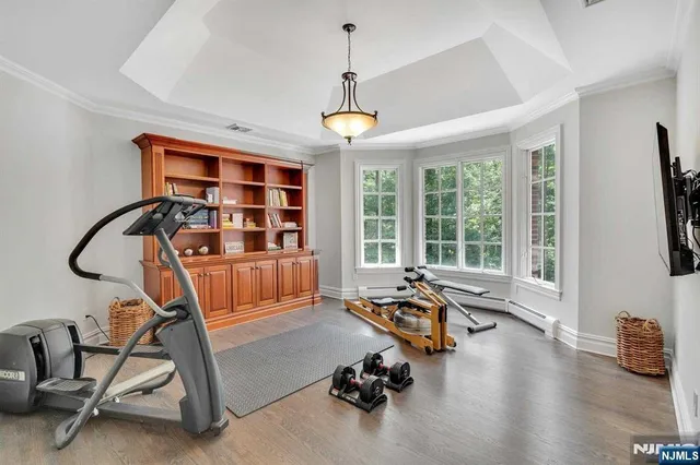 a large white room with a large window and wooden floor
