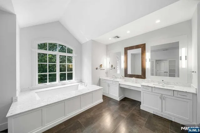 a bathroom with double sink and a mirror