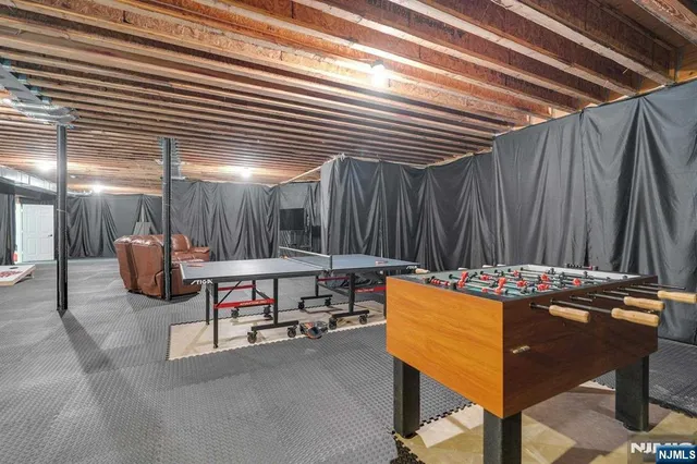 a view of a patio with couches table and chairs under an umbrella