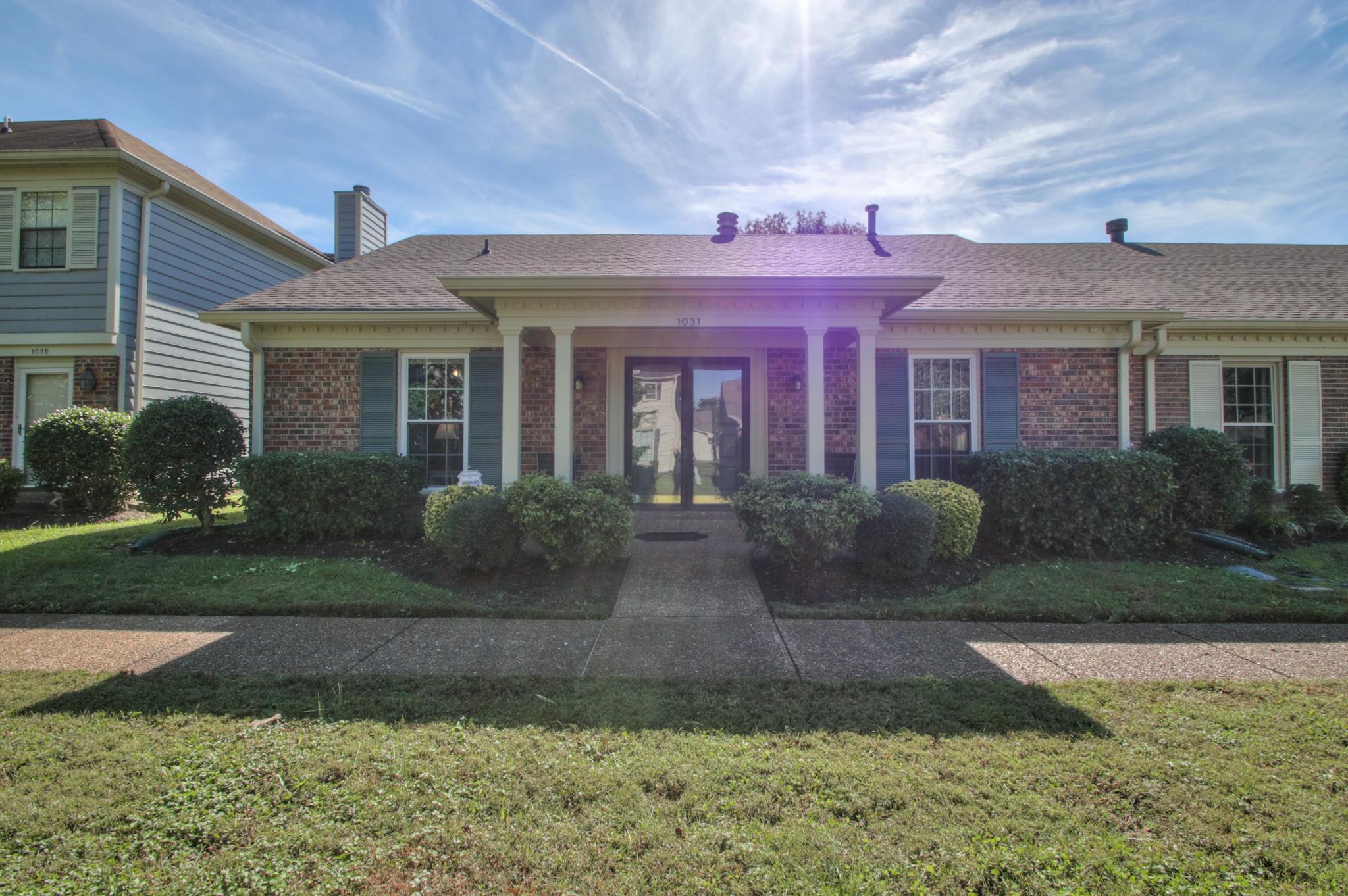 1031 General George Patton Road, Unit 1031 Nashville, TN 37221 - Photo 1 of 14 a front view of a house with a yard