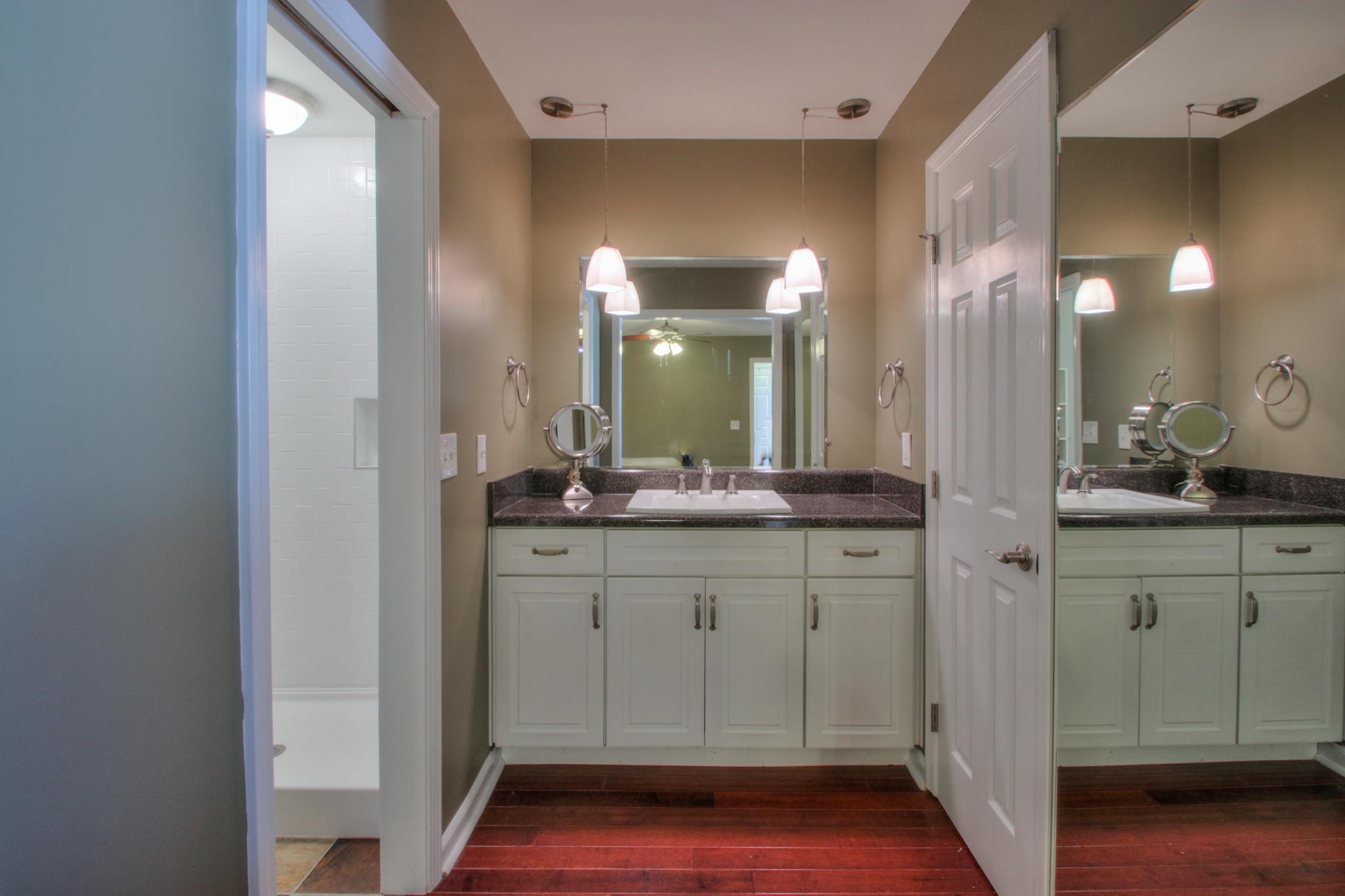 1031 General George Patton Road, Unit 1031 Nashville, TN 37221 - Photo 13 of 14 a bathroom with a sink and a mirror