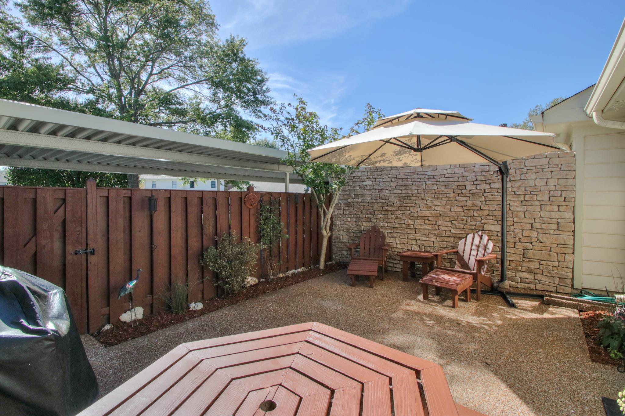 1031 General George Patton Road, Unit 1031 Nashville, TN 37221 - Photo 4 of 14 a backyard of a house with table and chairs