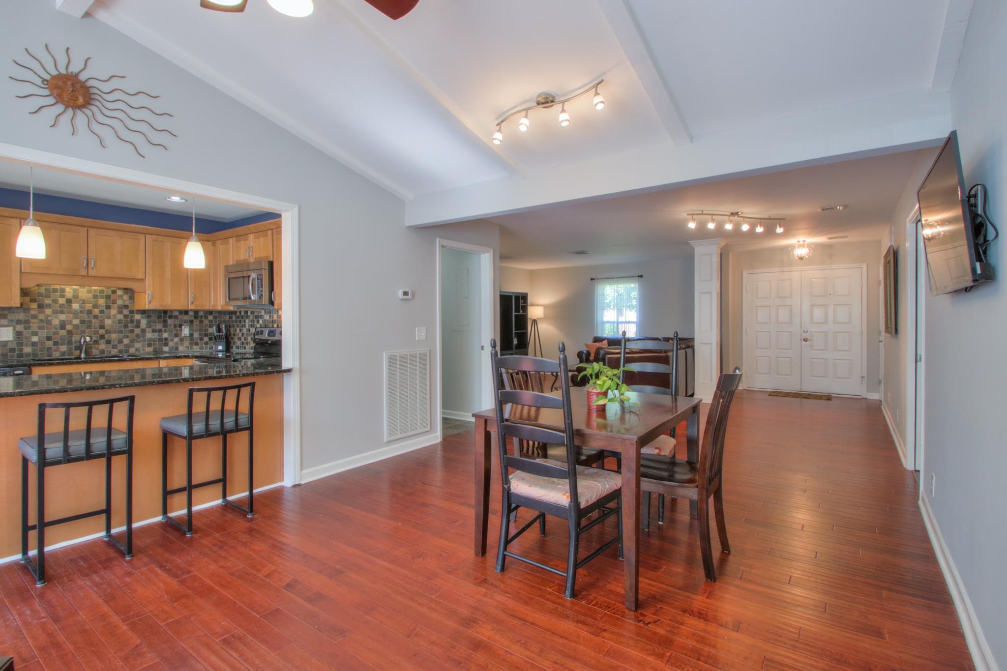 1031 General George Patton Road, Unit 1031 Nashville, TN 37221 - Photo 5 of 14 a view of a dining room with furniture and wooden floor