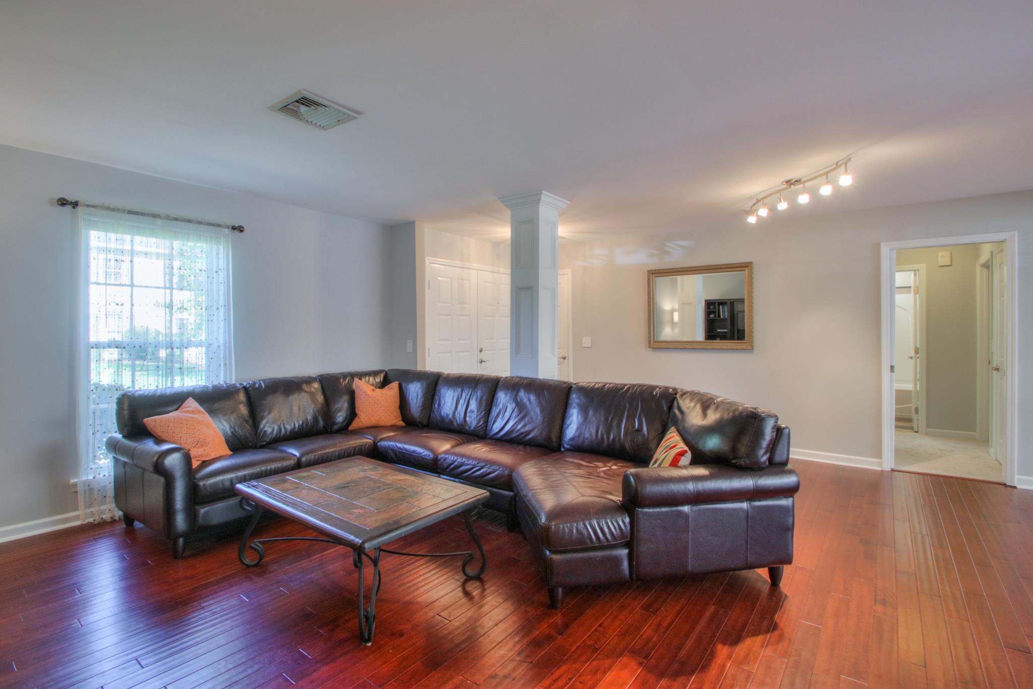 1031 General George Patton Road, Unit 1031 Nashville, TN 37221 - Photo 6 of 14 a living room with furniture and wooden floor