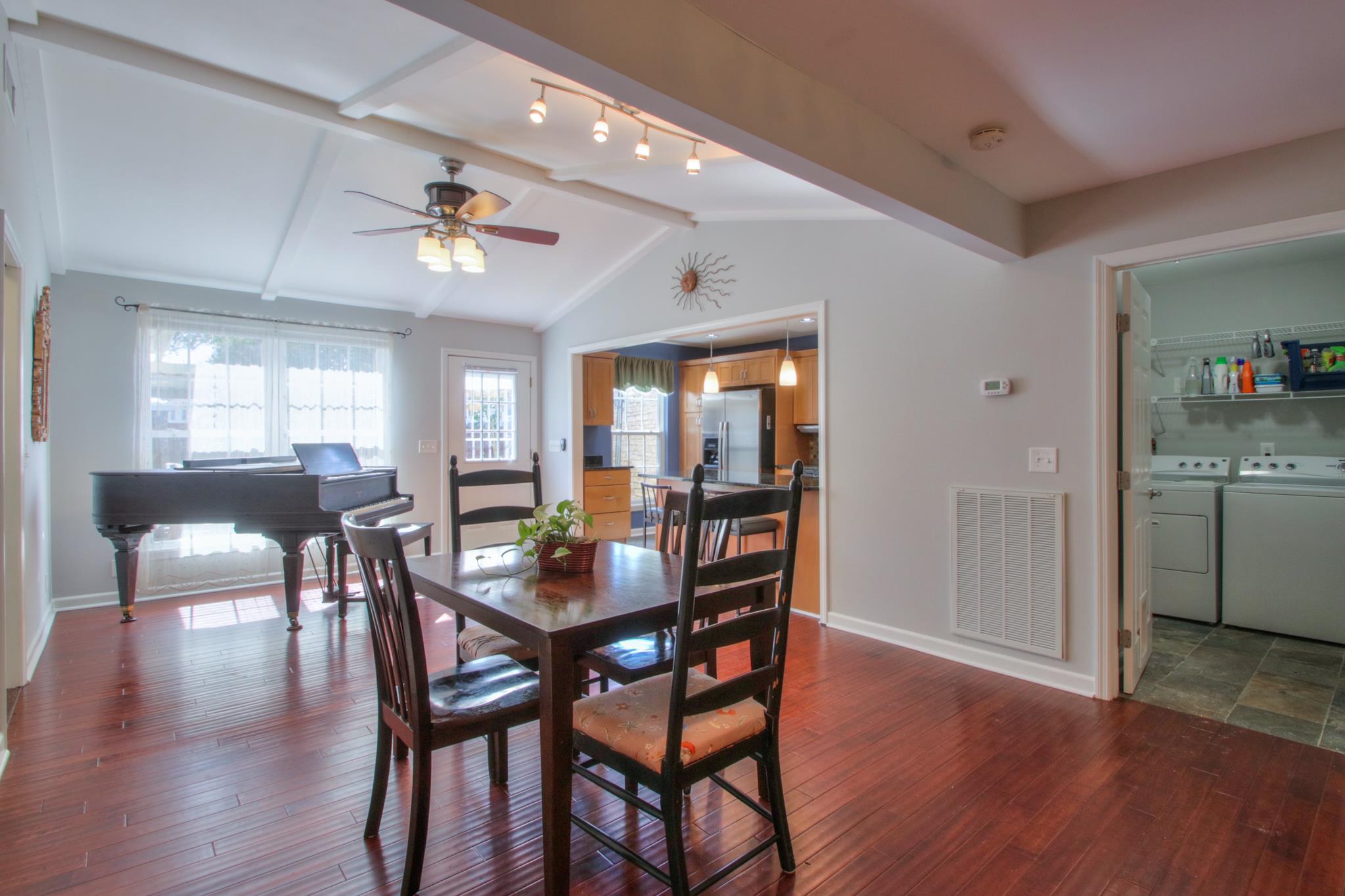 1031 General George Patton Road, Unit 1031 Nashville, TN 37221 - Photo 7 of 14 a view of a dining room with furniture and wooden floor