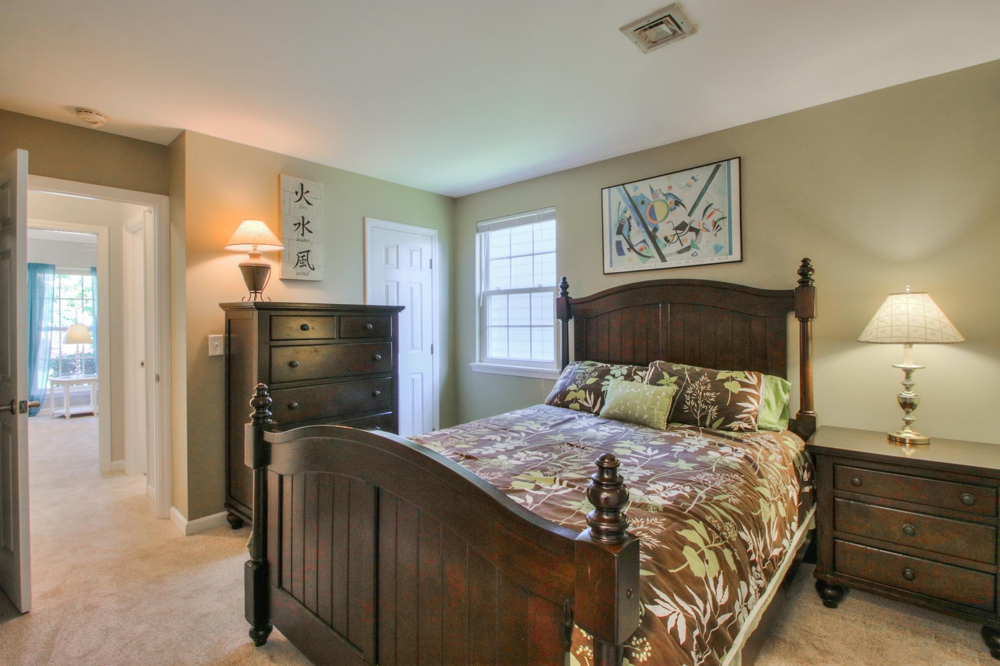 1031 General George Patton Road, Unit 1031 Nashville, TN 37221 - Photo 10 of 14 a bedroom with a bed and wooden floor