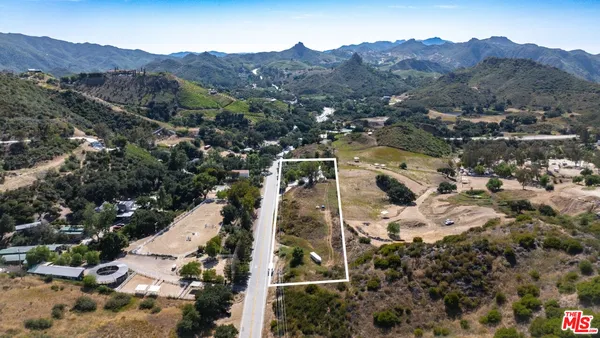 an aerial view of houses covered in trees
