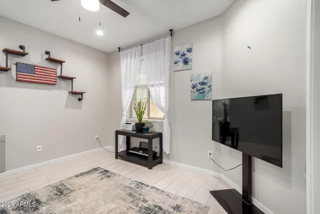 a living room with furniture kitchen view and a potted plant