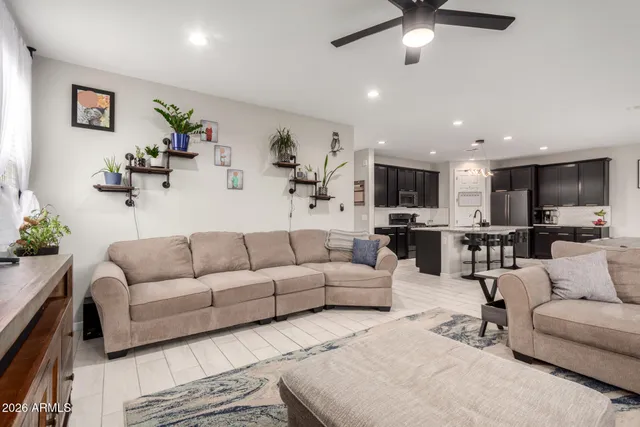 a bedroom with a bed a window and a flat screen tv