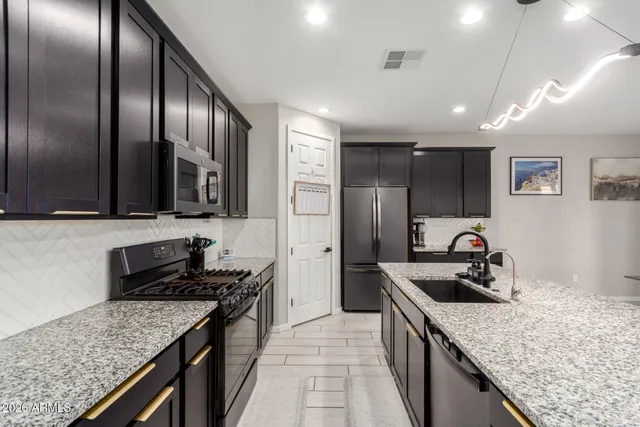 a spacious bedroom with a bed a couch and a flat screen tv