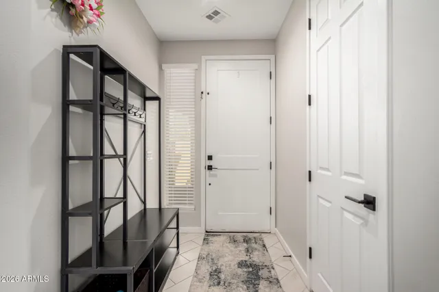 a kitchen with stainless steel appliances kitchen island granite countertop a refrigerator oven a sink a dining table and chairs with wooden floor