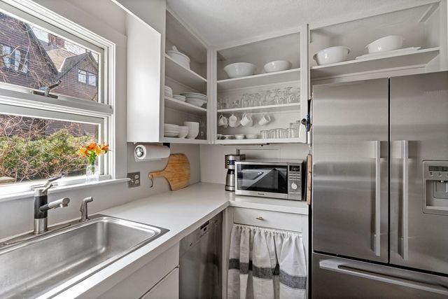 a kitchen with a refrigerator and a sink