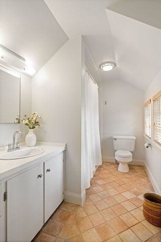 a balcony with wooden floor table and chairs
