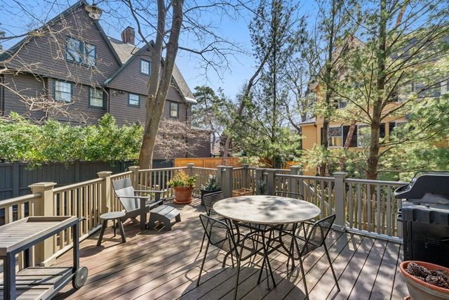 a view of a house with a small yard and wooden fence