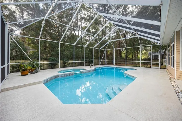 a view of a swimming pool with a tub in the room