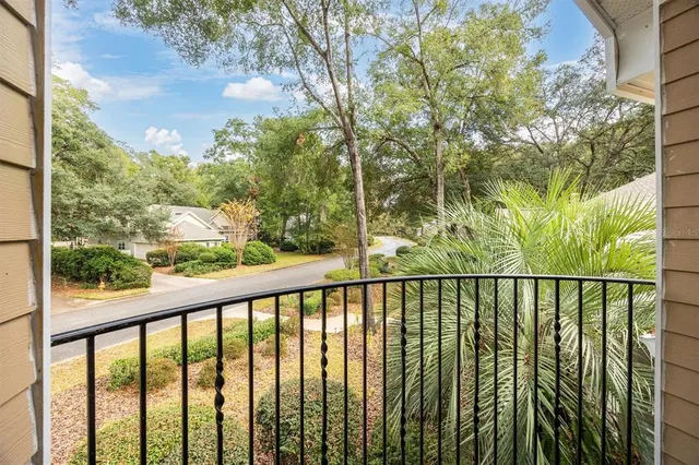 a view of a balcony with trees