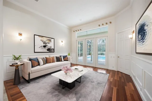 a living room with furniture and wooden floor