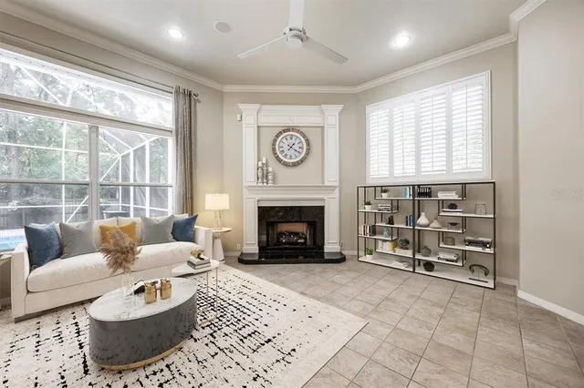 a living room with furniture a fireplace and a large window