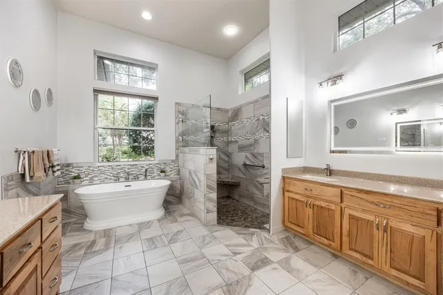 a bathroom with a granite countertop sink a toilet and bathtub