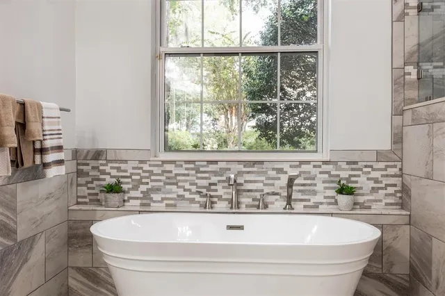 a bathroom with a bathtub and window