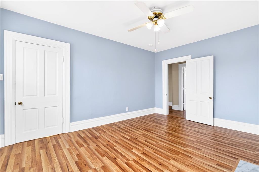 422 West 7th Avenue Tarentum, PA 15084 - Photo 17 of 50 wooden floor in an empty room with a chandelier fan