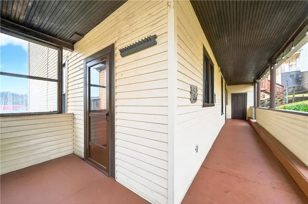 a view of a porch with wooden floor and stairs