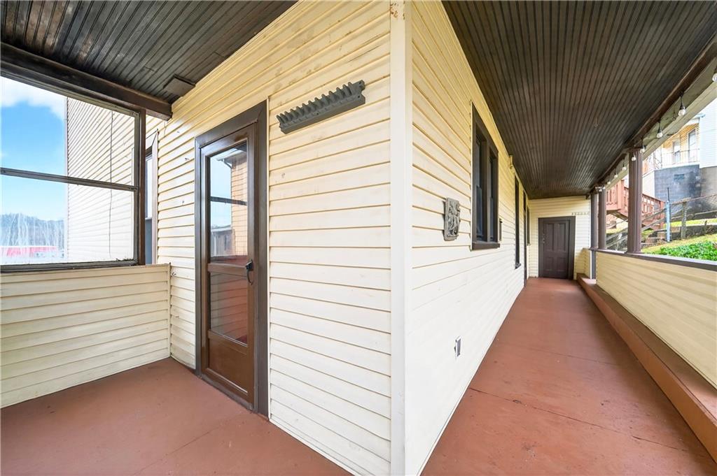 422 West 7th Avenue Tarentum, PA 15084 - Photo 30 of 50 a view of a porch with wooden floor and stairs