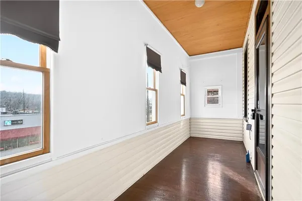 a view of an entryway with wooden floor