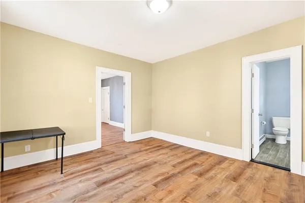 a view of an empty room and wooden floor