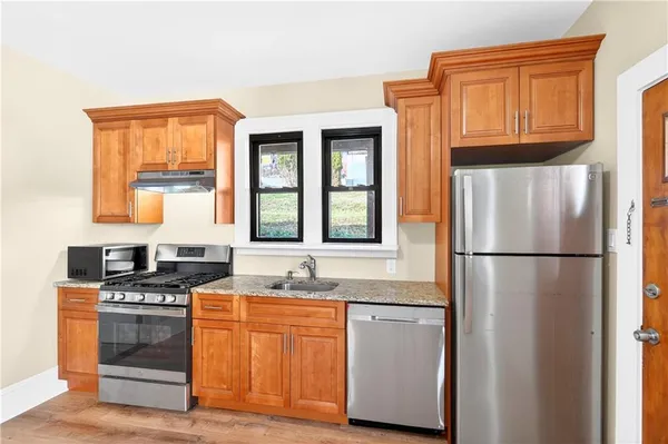 a kitchen with stainless steel appliances granite countertop a refrigerator stove and sink