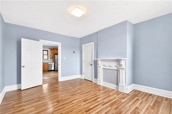a view of a kitchen with wooden floor and a sink